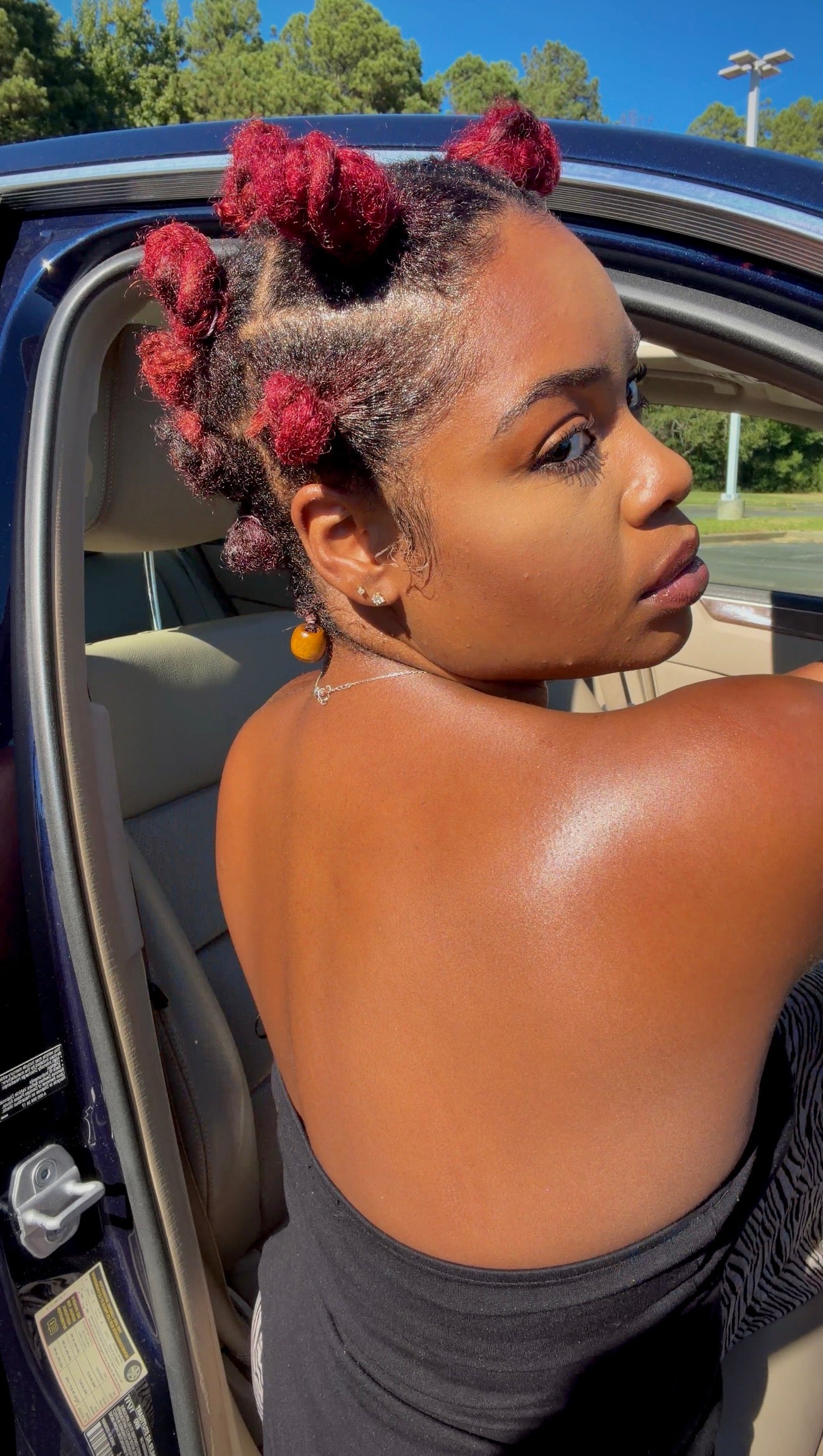 Jess looking over her shoulder in a car