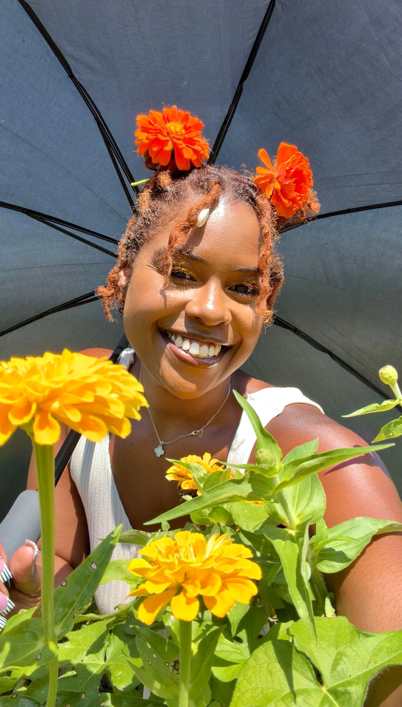 Jess smiling among orange flowers